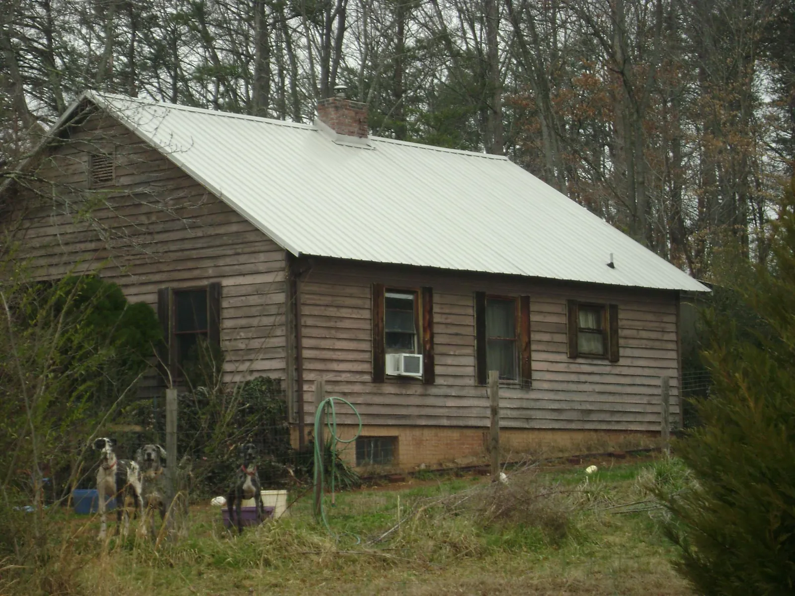 White metal roof on an old wood sided farmhouse, from a Metal Roof Installation job in Alstead